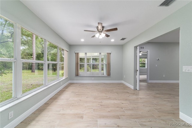 19028 SW 101st Pl, Dunnellon, FL 34432 - unfurnished sunroom with baseboards, wood finished floors, and recessed lighting