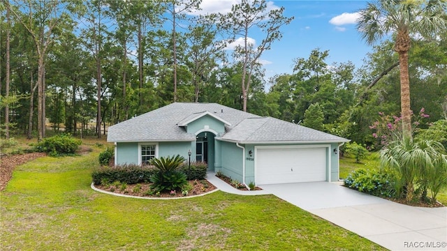 19028 SW 101st Pl, Dunnellon, FL 34432 - ranch-style home featuring driveway, an attached garage, a front lawn, stucco siding, and roof with shingles