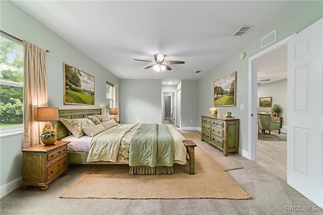 19028 SW 101st Pl, Dunnellon, FL 34432 - bedroom featuring light carpet, baseboards, and a ceiling fan