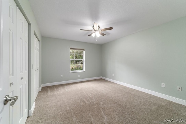 19028 SW 101st Pl, Dunnellon, FL 34432 - unfurnished bedroom featuring carpet floors, baseboards, and a ceiling fan