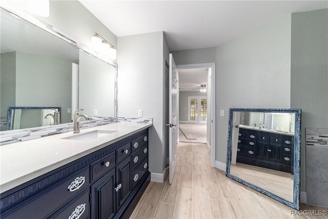 19028 SW 101st Pl, Dunnellon, FL 34432 - bathroom featuring vanity, wood finished floors, baseboards, and ceiling fan