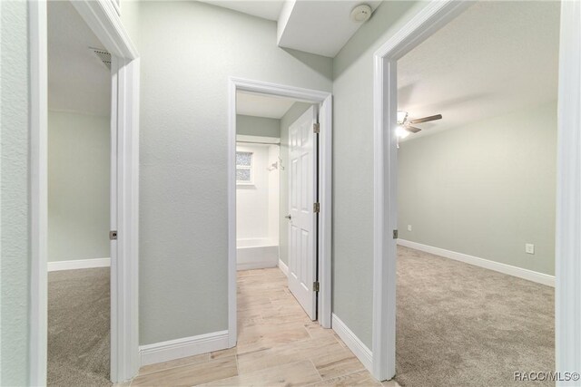 19028 SW 101st Pl, Dunnellon, FL 34432 - hallway with baseboards and light wood-style floors