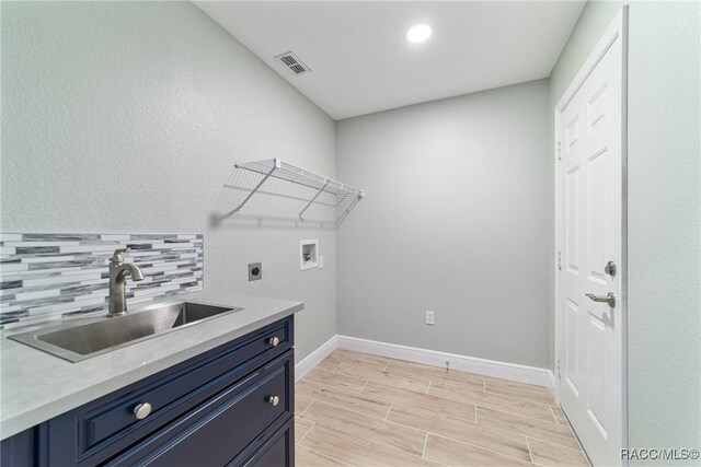 19028 SW 101st Pl, Dunnellon, FL 34432 - laundry room featuring hookup for an electric dryer, hookup for a washing machine, baseboards, cabinet space, and light wood-style floors