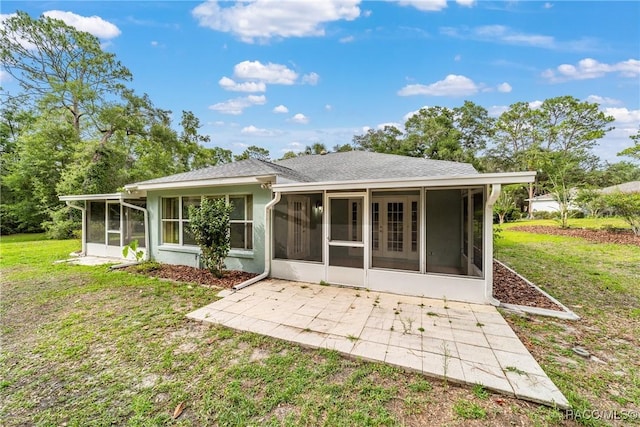 19028 SW 101st Pl, Dunnellon, FL 34432 - rear view of house with a sunroom, a patio, and a lawn