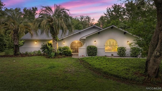 4357 N Indianhead Rd, Hernando, FL 34442 - view of front of home featuring stucco siding and a front lawn