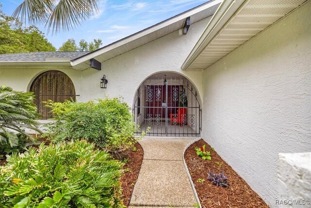 4357 N Indianhead Rd, Hernando, FL 34442 - property entrance featuring stucco siding and a gate