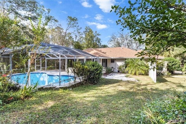 view of pool featuring a lanai, a yard, and a patio