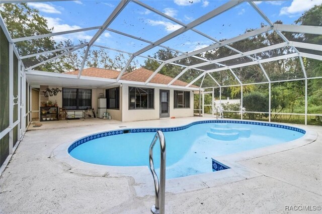 view of pool featuring a lanai and a patio