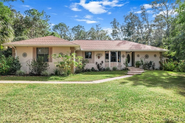 ranch-style home featuring a front lawn