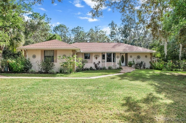 ranch-style home featuring a front yard