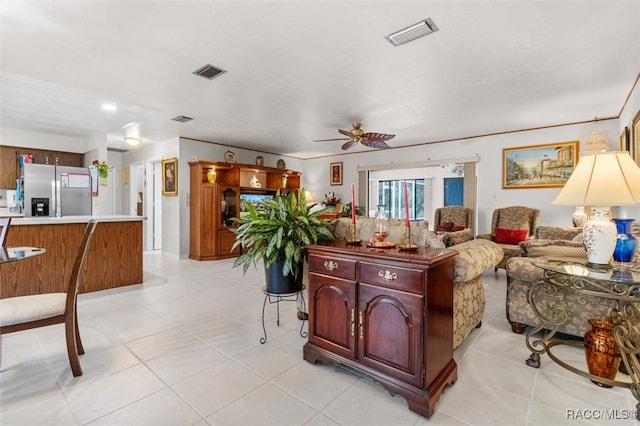 living room with ceiling fan and light tile patterned flooring