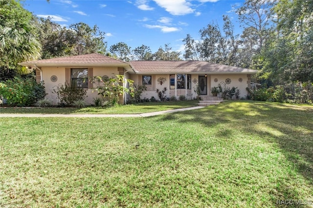 ranch-style home with a front lawn