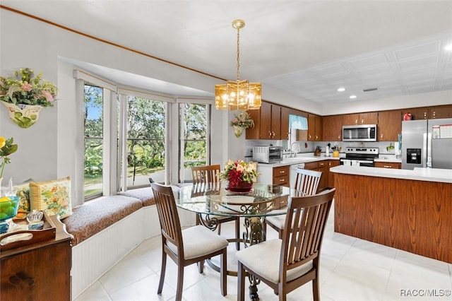 tiled dining area featuring an inviting chandelier