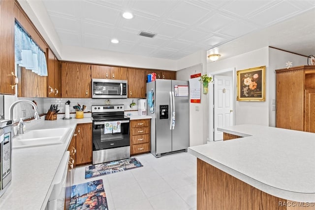 kitchen featuring backsplash, sink, and stainless steel appliances