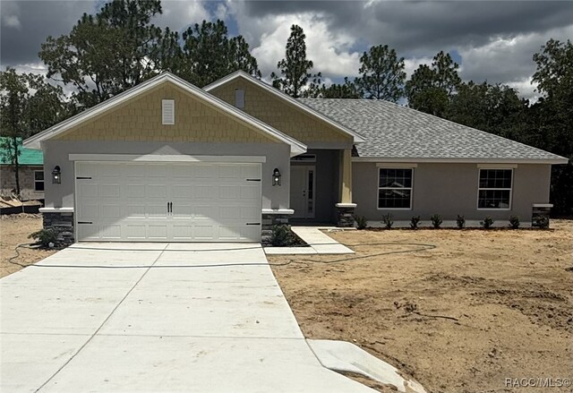 777 W Hallam Dr, Citrus Springs, FL 34434 - single story home featuring an attached garage, driveway, stucco siding, and a shingled roof