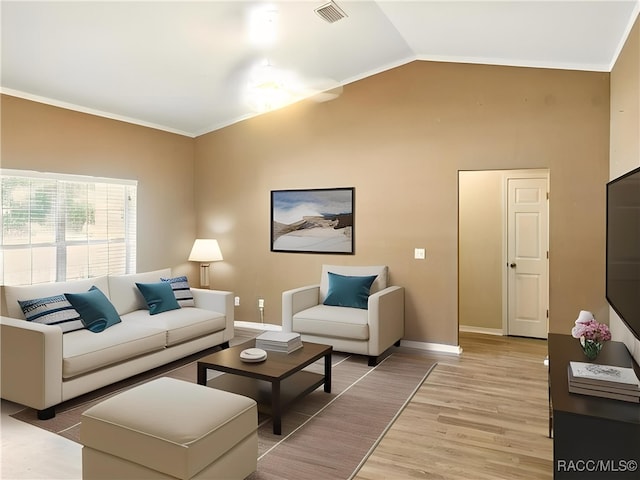 8599 N Messina Loop, Crystal River, FL 34428 - living room featuring light wood finished floors, baseboards, and vaulted ceiling