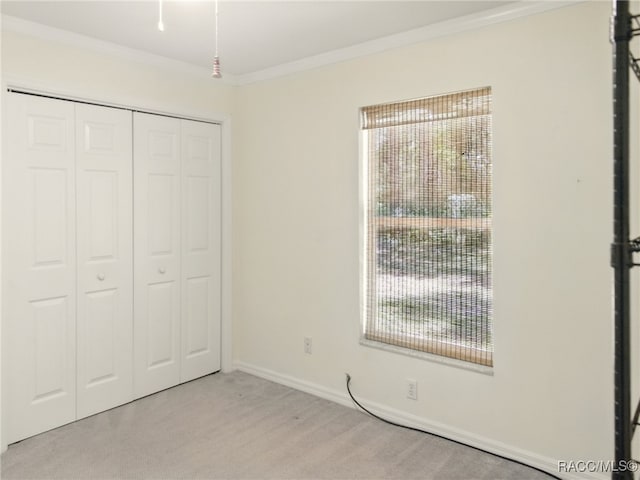 8599 N Messina Loop, Crystal River, FL 34428 - unfurnished bedroom with light colored carpet, a closet, ornamental molding, baseboards, and multiple windows
