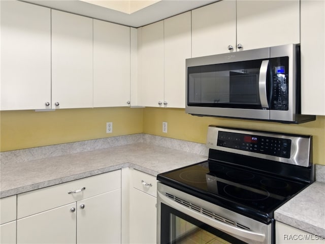 8599 N Messina Loop, Crystal River, FL 34428 - kitchen featuring stainless steel appliances, light countertops, and white cabinetry