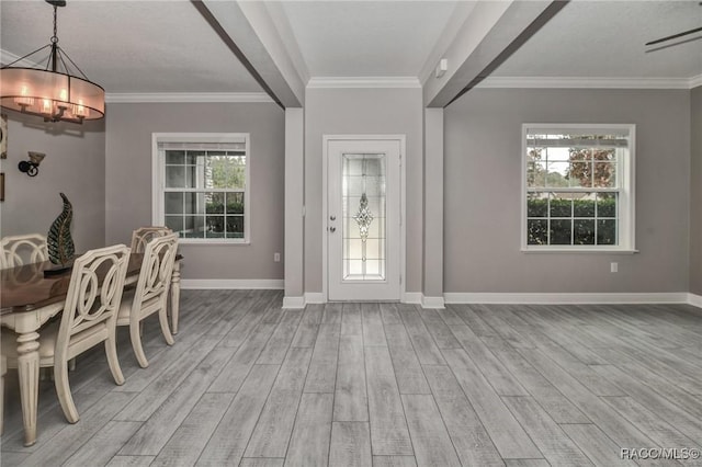 foyer entrance with crown molding and light hardwood / wood-style floors