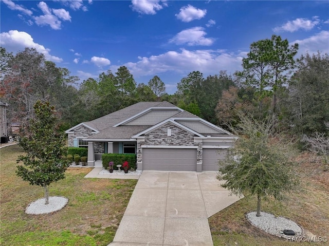 view of front of property with a garage and a front lawn