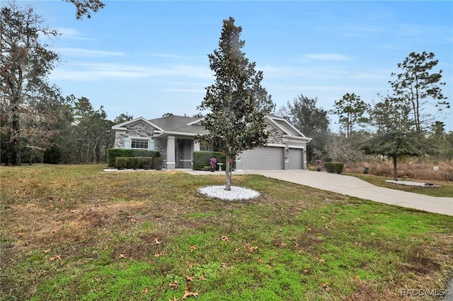 view of front of property with a garage and a front lawn