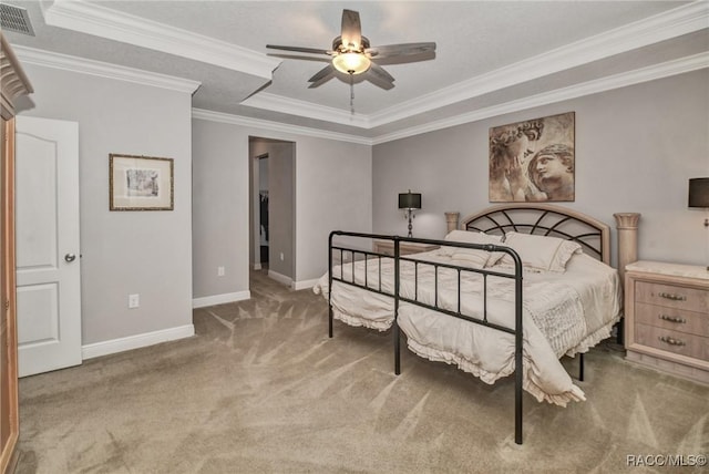 bedroom with a tray ceiling, ornamental molding, and ceiling fan