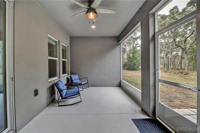 sunroom featuring ceiling fan and a healthy amount of sunlight