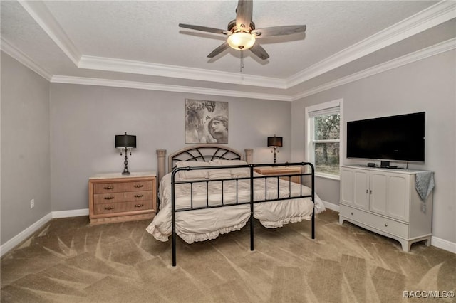 bedroom with crown molding, a textured ceiling, a tray ceiling, ceiling fan, and carpet