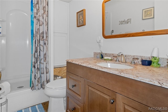 bathroom with toilet, vanity, wood-type flooring, and walk in shower