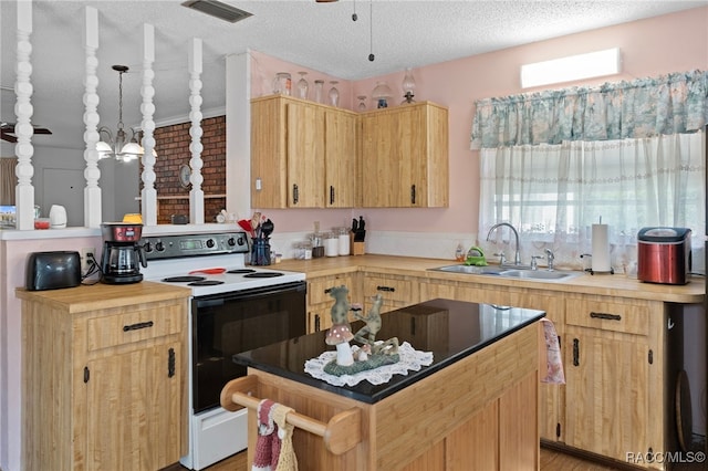 kitchen featuring white range with electric cooktop, sink, light wood-type flooring, decorative light fixtures, and a kitchen island