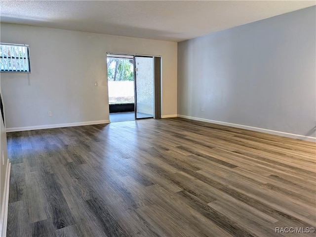 9781 E Goldfinch Ln, Inverness, FL 34450 - spare room featuring dark wood-style floors and baseboards