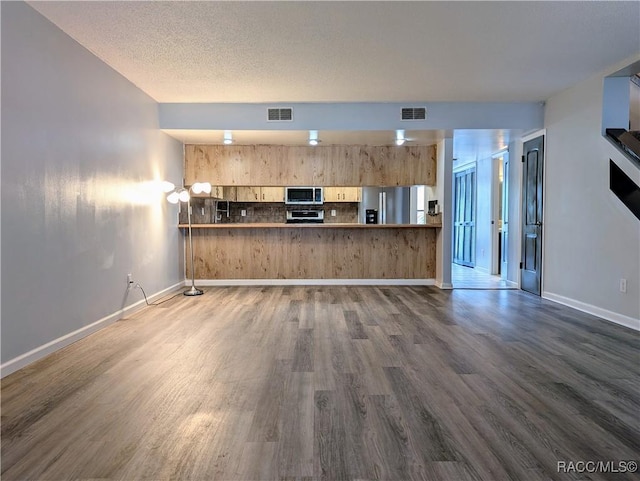 9781 E Goldfinch Ln, Inverness, FL 34450 - unfurnished living room featuring dark wood finished floors and baseboards