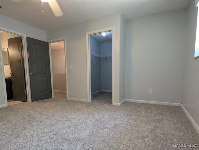 9781 E Goldfinch Ln, Inverness, FL 34450 - unfurnished bedroom featuring light carpet, baseboards, a walk in closet, and a closet