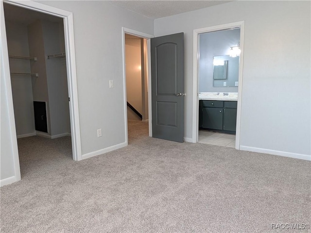 9781 E Goldfinch Ln, Inverness, FL 34450 - unfurnished bedroom with light carpet, a spacious closet, baseboards, a closet, and ensuite bathroom