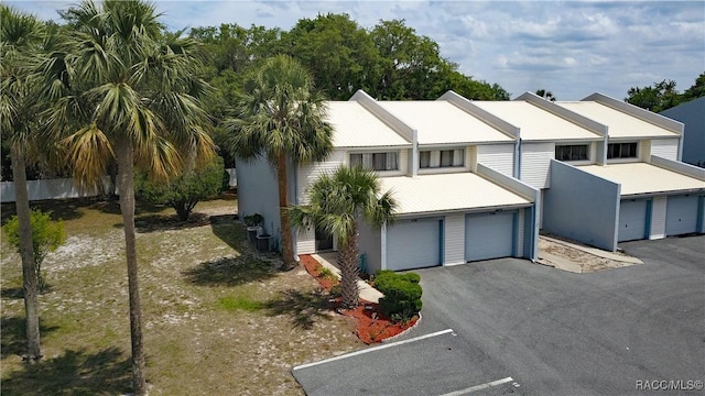 9781 E Goldfinch Ln, Inverness, FL 34450 - view of front facade with an attached garage and asphalt driveway