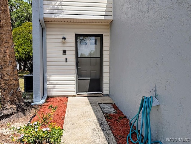 9781 E Goldfinch Ln, Inverness, FL 34450 - doorway to property featuring stucco siding