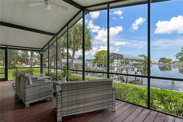 sunroom / solarium with vaulted ceiling with beams, a water view, a wealth of natural light, and ceiling fan