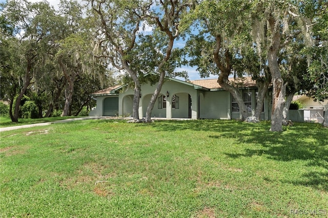 view of front of property with a front lawn and a garage