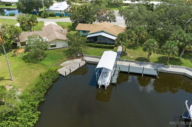 dock area with a lawn and a water view