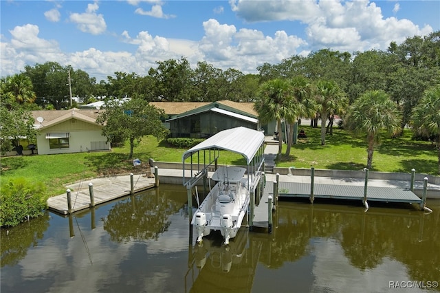 dock area with a yard and a water view