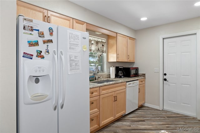 kitchen featuring light brown cabinets, white appliances, dark wood-type flooring, and sink