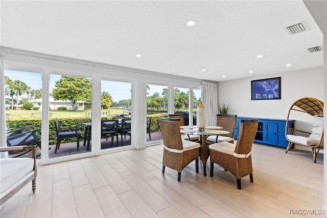 dining space with light hardwood / wood-style flooring