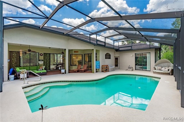 view of pool featuring ceiling fan, a patio area, an outdoor hangout area, and glass enclosure