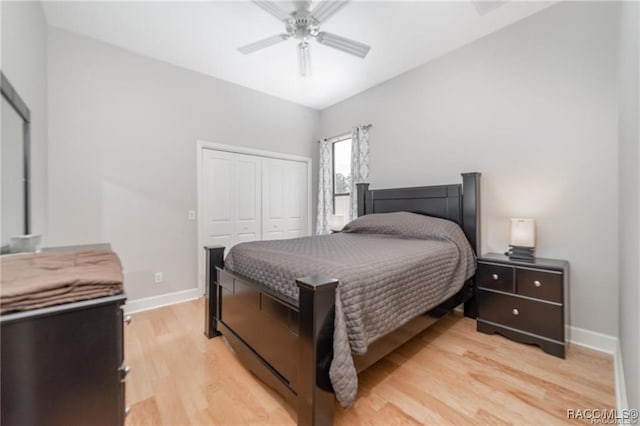 bedroom featuring ceiling fan, a closet, and light wood-type flooring