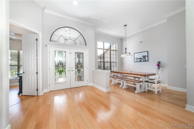 entryway featuring hardwood / wood-style floors, ornamental molding, and french doors