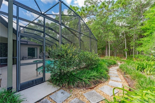 exterior space with a patio and glass enclosure