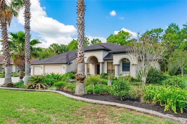 mediterranean / spanish-style house with a front lawn and a garage