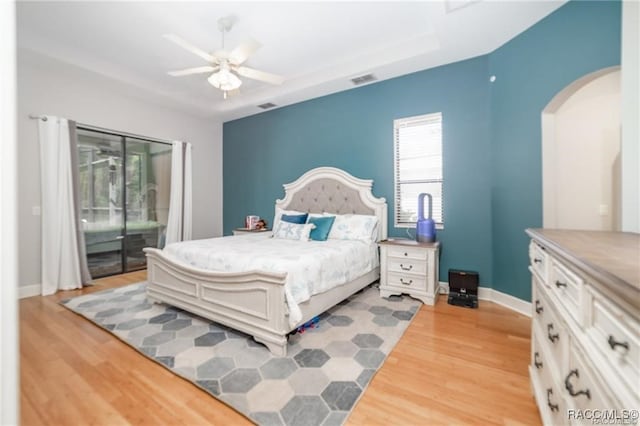 bedroom featuring access to exterior, light wood-type flooring, and ceiling fan