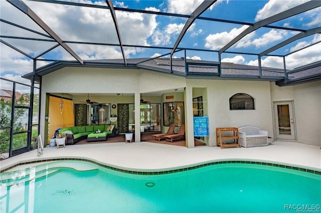 view of swimming pool featuring a lanai, an outdoor hangout area, ceiling fan, and a patio area