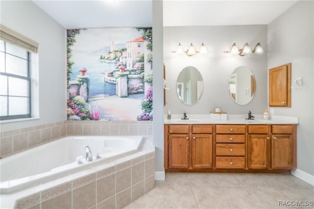 bathroom with tile patterned floors, vanity, and a relaxing tiled tub